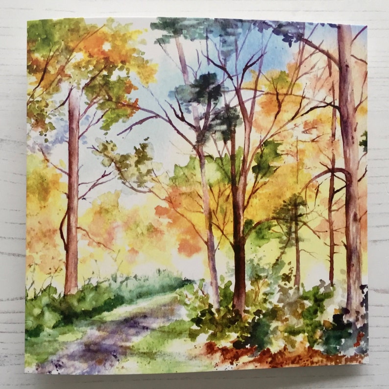 May include: Watercolor painting of a forest path with trees in autumn colors. The trees are a mix of yellow, orange, red, and green. The path is winding through the trees and leads to a clearing in the distance.