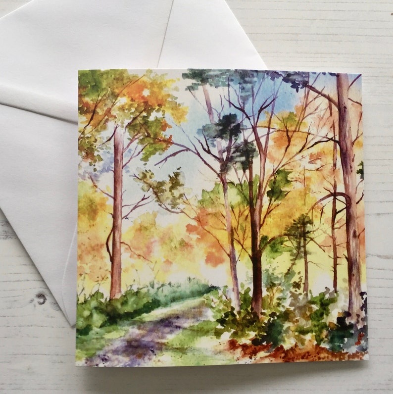 May include: Watercolor painting of a forest path with trees in autumn colors. The path winds through the trees, with leaves in shades of yellow, orange, and red.