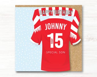 May include: A birthday card featuring a red soccer jersey design with the name "JOHNNY" and the number "15". The card includes the text "HAPPY BIRTHDAY" and "SPECIAL SON" on a light blue background with white dots.