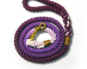 May include: Purple, pink, and white ombre cotton rope dog leash with a gold metal clasp.