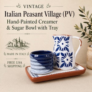 May include: A hand-painted creamer and sugar bowl set with a tray. The creamer is white with blue floral patterns and distressed edges. The sugar bowl is dark blue with a white textured base. The rectangular tray has a terracotta-colored rim.