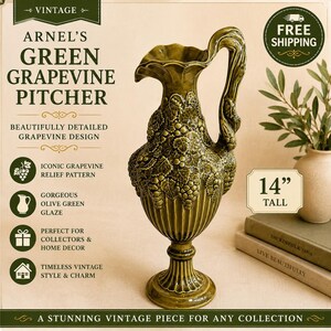 May include: An Arnel's olive green ceramic pitcher featuring a raised grapevine relief pattern, a fluted base, and a curved handle. The pitcher stands 14 inches tall and displays a glossy finish with intricate grape and leaf detailing throughout.