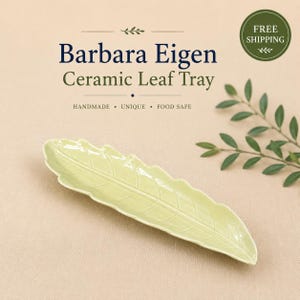 May include: A light green ceramic leaf tray with a glossy finish and embossed vein details. The text on the image reads: Barbara Eigen Ceramic Leaf Tray, Handmade, Unique, Food Safe, and Free Shipping. The tray is long and narrow in shape.