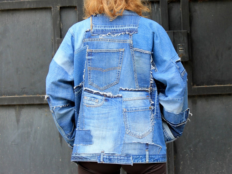 May include: A blue denim jacket made from repurposed denim with multiple pockets and frayed edges.