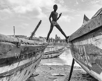 Senegalese Boy Walking on the Boats, Travel Photography, African Black and White Photography, Fine Art Photography, Vertical Wall Art Print