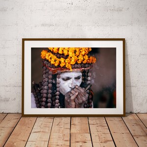 Portrait of Naga Baba, an Indian Holy Man Sadhu at Kumbh Mela: Wearing Colorful Orange Flowers , Beads and Smoking Chilum India Print image 2