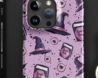 May include: Purple iPhone case with a repeating pattern of witch hats, eyeballs, and books that say "Spell Book".