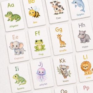 Puede incluir: Tarjetas del alfabeto con ilustraciones de animales. Cada tarjeta muestra una letra y un animal, como un caimán, una abeja, una vaca, un delfín, un elefante, una rana, una jirafa, un hipopótamo, una iguana, una medusa, un koala y un león.