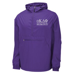 May include: A purple anorak jacket with a hood and a front pocket. The jacket features a half-zip closure and the Greek letters "αΚΔΦ" with the text "alpha Kappa Delta Phi" printed in white.