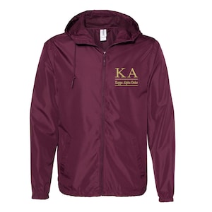 May include: Burgundy windbreaker jacket with a gold zipper and a gold embroidered logo that says "KA Kappa Alpha Order".