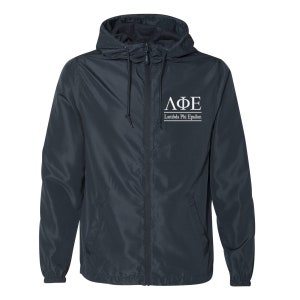 May include: A navy blue windbreaker jacket with a white zipper and a white embroidered logo that says "ΛΦΕ Lambda Phi Epsilon".