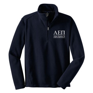 May include: A navy blue fleece pullover with a quarter zip closure. The front of the pullover has a white embroidered logo that says "ΑΕΠ Alpha Epsilon Pi".