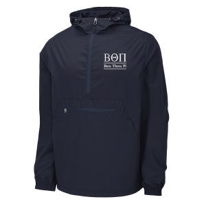 May include: Navy blue anorak jacket with a hood and a front pocket. The jacket features a white logo with the Greek letters ΒΘΠ and the words "Beta Theta Pi". The jacket has a zipper closure and a drawstring hood.