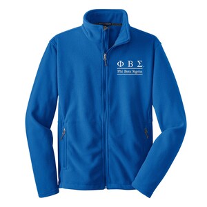 May include: A royal blue fleece jacket with a zipper closure and two pockets. The jacket has a white embroidered logo that says "ΦΒΣ Phi Beta Sigma".