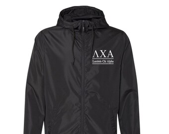 May include: Black windbreaker jacket with a white embroidered logo that says "AXA Lambda Chi Alpha".