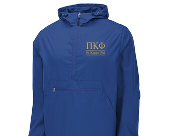 May include: A royal blue windbreaker jacket with a gold embroidered Pi Kappa Phi logo and the words "Pi Kappa Phi" underneath.