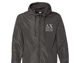 May include: A dark gray hooded windbreaker jacket with a white embroidered logo that says "ΔΧ Delta Chi".