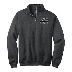 May include: A dark gray 1/4 zip sweatshirt with a white embroidered Delta Sigma Phi logo and the text "Delta Sigma Phi".