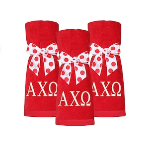 May include: Three red towels with white polka dot bows and the letters AXQ embroidered in white.