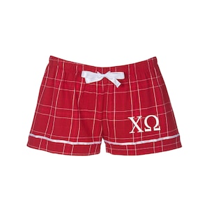 May include: Red and white plaid pajama shorts with a white bow and the letters "XO" embroidered in white.