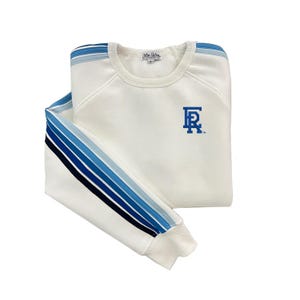 May include: White sweatshirt with blue and navy stripes on the sleeves and a blue "FR" logo on the front.