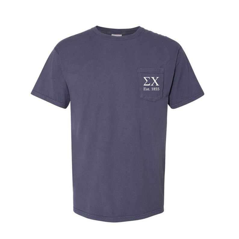May include: A dark blue t-shirt with a white pocket featuring the letters "&Sigma;&Chi;" and the text "Est. 1855".