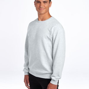 May include: A heather grey sweatshirt with long sleeves and a crew neck.
