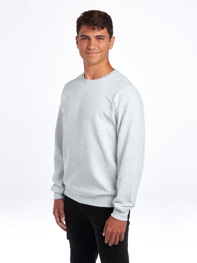 May include: A heather grey sweatshirt with long sleeves and a crew neck.