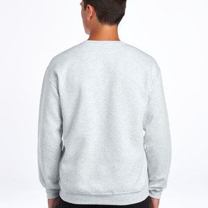 May include: A heather gray sweatshirt with long sleeves and a crew neck.