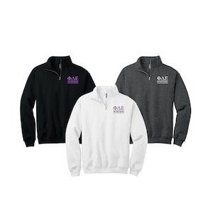 May include: Three quarter-zip sweatshirts in black, white, and heather gray. Each sweatshirt features a purple embroidered Phi Delta Epsilon logo on the left chest.