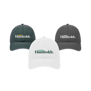 May include: Three baseball caps in different colors. The caps are all the same style, with a curved brim and a mesh back. The front of each cap has the text "Cal Poly Humboldt." The caps are in black, gray, and white.