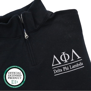 May include: Black quarter-zip sweatshirt with a white embroidered Delta Phi Lambda logo and the text "Delta Phi Lambda". The sweatshirt also has a green circle with the text "OFFICIAL LICENSED PRODUCT" and a Roman numeral III.