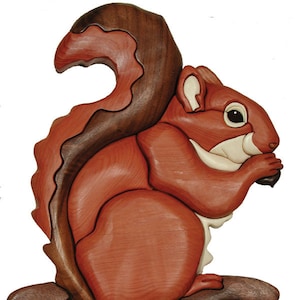 May include: A wooden squirrel sculpture with a bushy tail, sitting on a brown base and holding a nut in its paws. The squirrel is carved from different types of wood, creating a realistic and detailed design.