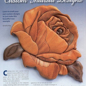 May include: A close-up of a wooden rose intarsia design. The rose is made of different types of wood, creating a beautiful pattern. The text "From Photo to Pattern Custom Intarsia Designs" is at the top of the image.