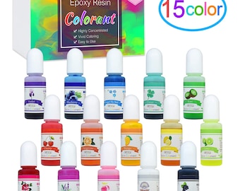 May include: A set of 15 small bottles of epoxy resin colorant. The bottles are labeled with different colors and names, such as "Violet", "Blueberry", "Cherry", "Tangerine", "Mango", "Lemon", "Lime", "Rose", "Lavender", "Peach", "Pearl", and "Black Currant". The bottles are arranged in three rows of five bottles each. The bottles are all clear and have white caps. The bottles are sitting on a white surface. The image also includes a box with the text "Epoxy Resin Colorant" and "15 colors".