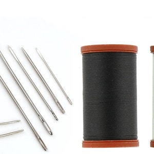 May include: A collection of sewing needles and spools of thread. The needles are silver and come in various sizes and shapes, including curved and straight. Two spools of thread are visible, one black and one light green, with brown caps.
