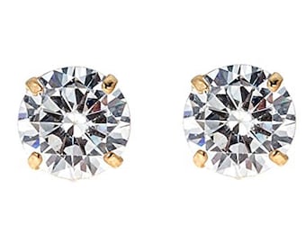 May include: A pair of gold stud earrings with clear round cubic zirconia stones.