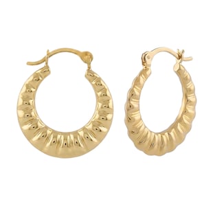 May include: A pair of gold hoop earrings featuring a thick, rounded profile with a distinct ribbed, textured surface. Each earring is designed with a hinged post closure at the top, showcasing a polished, reflective metallic finish throughout.