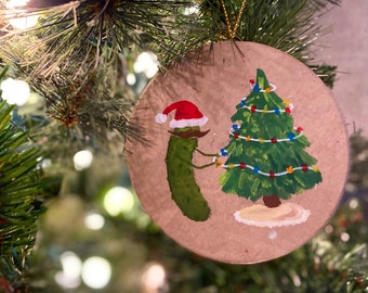 Whimsical Pickle in a Santa Hat Decorating a Christmas Tree Hand Painted Ornament