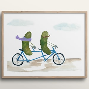 May include: A watercolor painting of two green pickles riding a blue tandem bicycle. The pickle in the front has a brown mustache and the pickle in the back has a purple scarf.