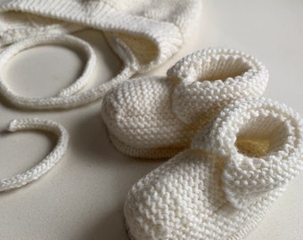 Hand knitted newborn hat and bootee set.