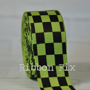 May include: Green and black checkered ribbon. The ribbon is rolled up and the checkered pattern is visible.