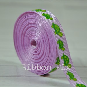 May include: A roll of lavender satin ribbon with a repeating pattern of green turtles. The ribbon is 1 inch wide.