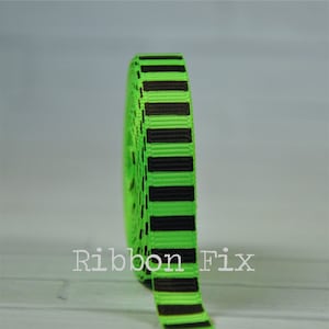 May include: A roll of green and black striped ribbon. The ribbon is 1 inch wide and has a satin finish.