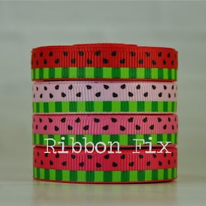 May include: Stack of four watermelon-themed ribbon rolls. The ribbon is red, pink, and green with black watermelon seeds. The ribbon is stacked on a white surface. The text "Ribbon Fix" is visible in the image.