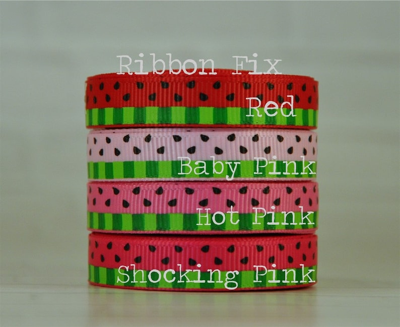 May include: Four rolls of watermelon-patterned ribbon in different shades of pink and red. The ribbon is labeled "Ribbon Fix" and the colors are "Red", "Baby Pink", "Hot Pink", and "Shocking Pink".