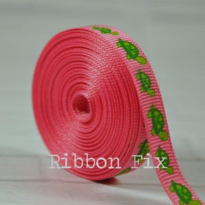 May include: Pink ribbon with a repeating pattern of green turtles. The ribbon is rolled up and the text "Ribbon Fix" is visible in the lower center of the image.