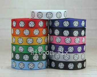 May include: A stack of 12 rolls of white volleyball patterned ribbon in various colours, including red, orange, yellow, green, blue, pink, purple, navy, grey, and black. The ribbon is 1.5 inches wide and is ideal for adding a sporty touch to crafts, gifts, and decorations.
