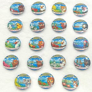 May include: A collection of round, colorful souvenir pins. Each pin features a unique illustration of a city or region, along with the text "ETERNAL HAPPINESS 2026". The pins showcase various animals and landmarks.