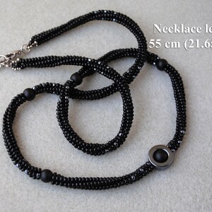 May include: Black beaded necklace with a silver clasp and a black hematite pendant. Necklace length: 55 cm (21.65 inch)